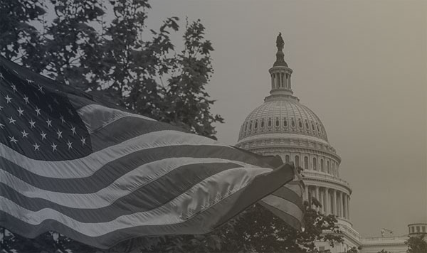 The American flag fying in front of a government building